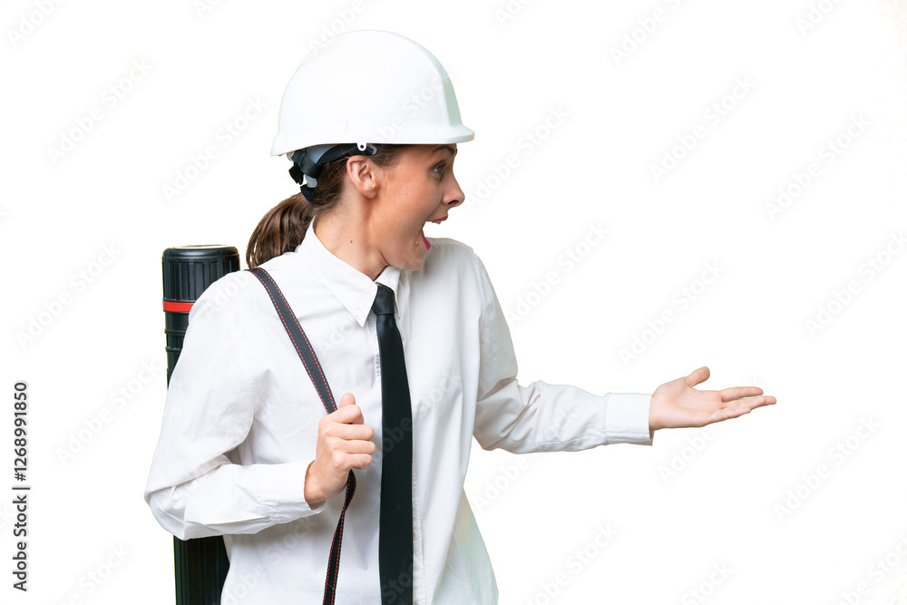 Young architect woman with helmet and holding blueprints over isolated background with surprise expression while looking side Young architect woman with helmet and holding blueprints over isolated background with surprise expression while looking side
