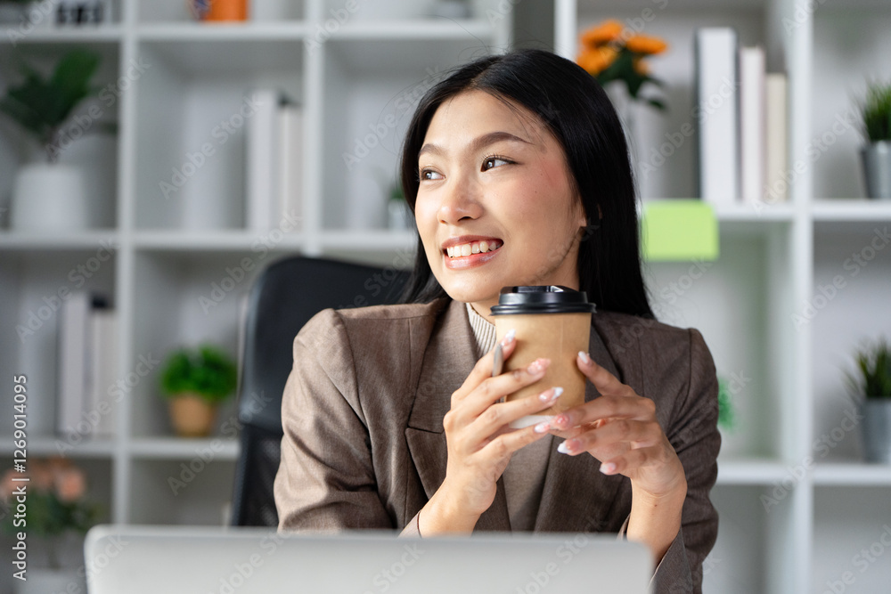 Cheerful businesswoman holding a coffee cup and smiling in a modern office