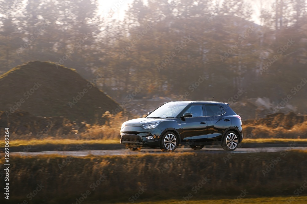 Small hatchback navigating country road view