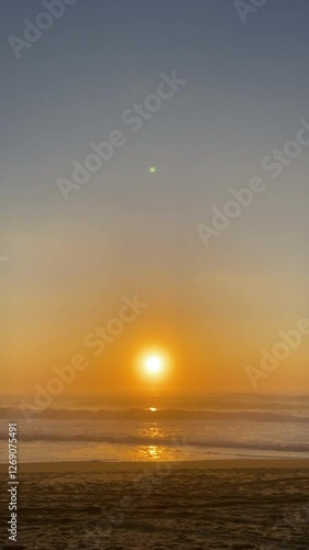 Cinematic sunset on the ocean. Sunset on the beach in Portugal. Golden sunset on the ocean beach. photo