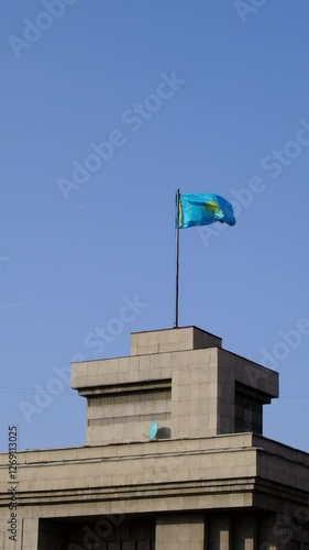 Vertical View of Kazakh National Flag Waving in the Wind – Patriotic Scene Captured with Static Camera for Stock Footage photo