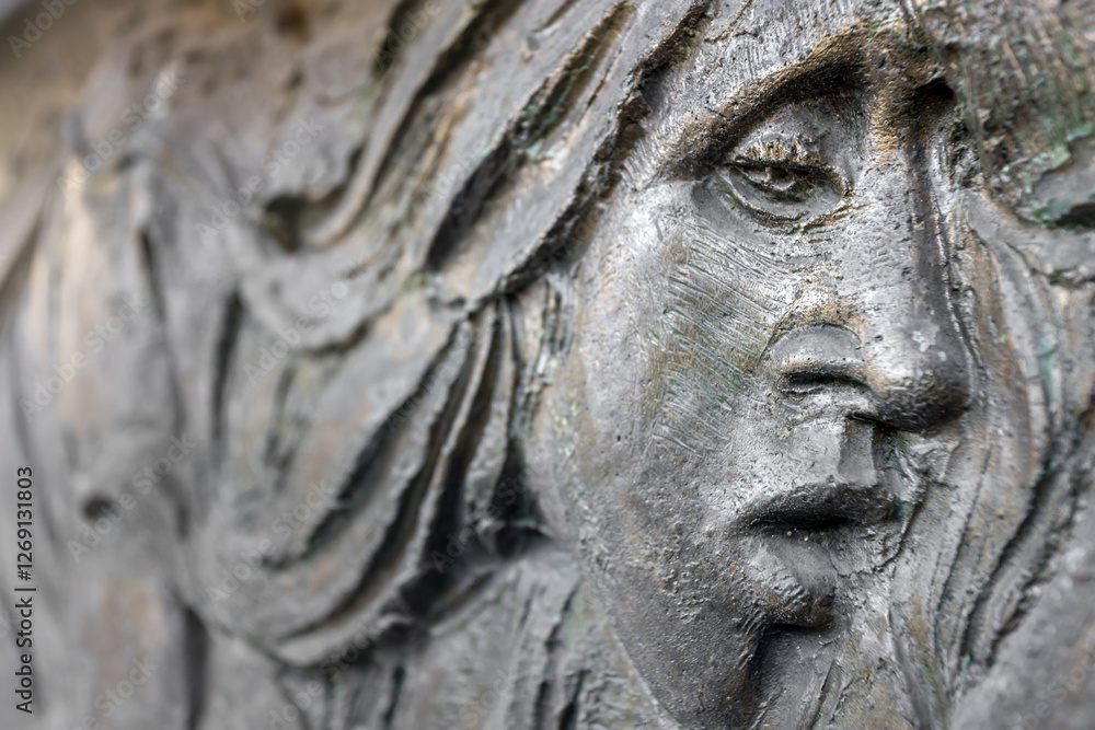 Bas-relief face of a suffering woman Bas-relief face of a suffering woman
