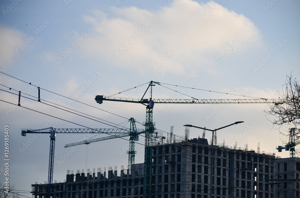 Crane and building under construction, showcasing urban development and architectural progress. Crane and building under construction, showcasing urban development and architectural progress.