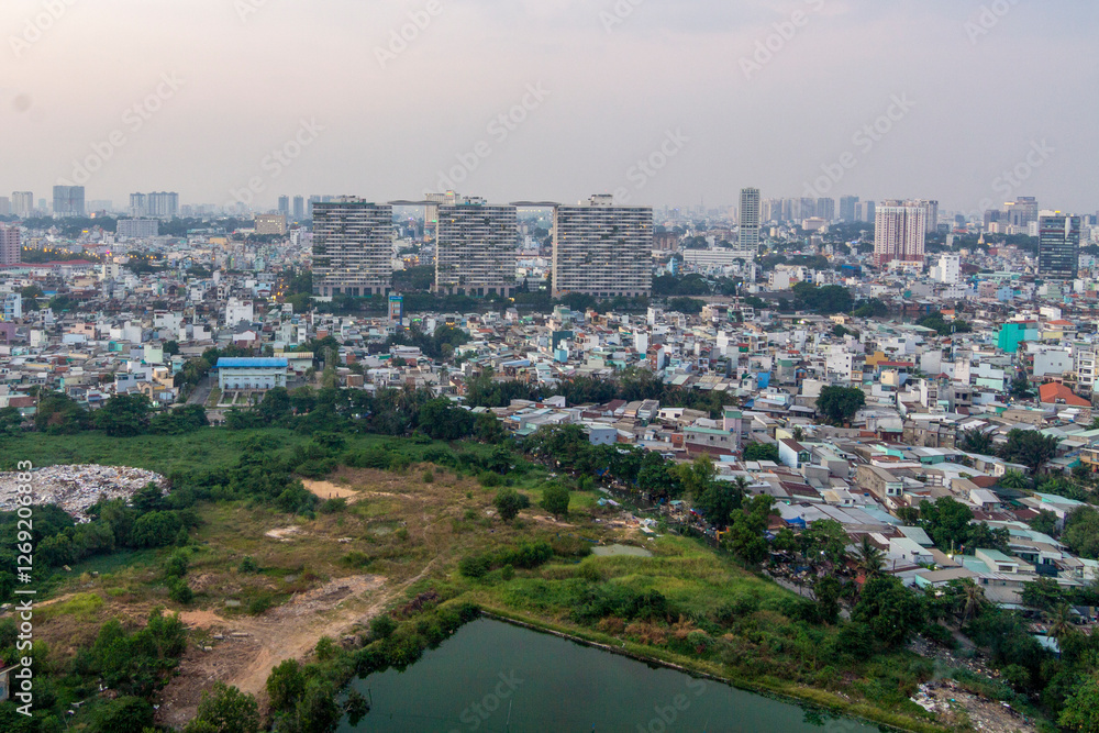 Fototapeta premium Saigon, Vietnam - 30 Jun, 2022 - An aerial view of Saigon shows high-rise buildings and apartments.