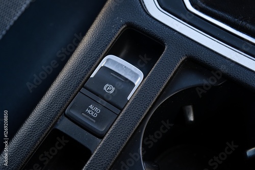 Close-up of car parking brake and auto hold button
