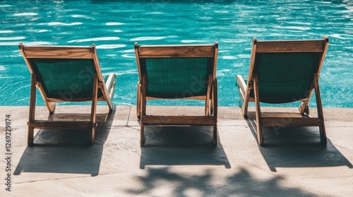 Beautiful shot of three sun loungers near the pool