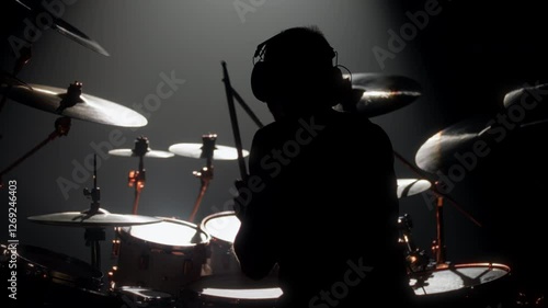 Skilled drummer punching hi-hats, playing music in rock gig, rearview in dark. Hobby and passion, young adult man rehearsing to beat rhythm, enjoy modern music, cool guy rocking crowd in concert hall