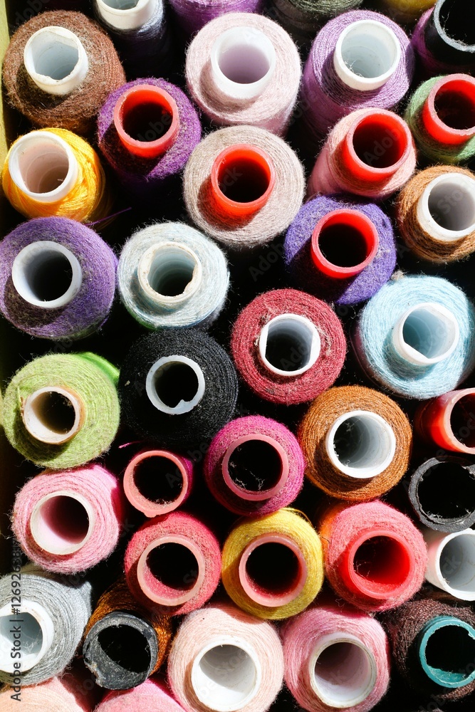 Top view, high angle of colorful spools thread can trigger trypophobia for some people Top view, high angle of colorful spools thread can trigger trypophobia for some people