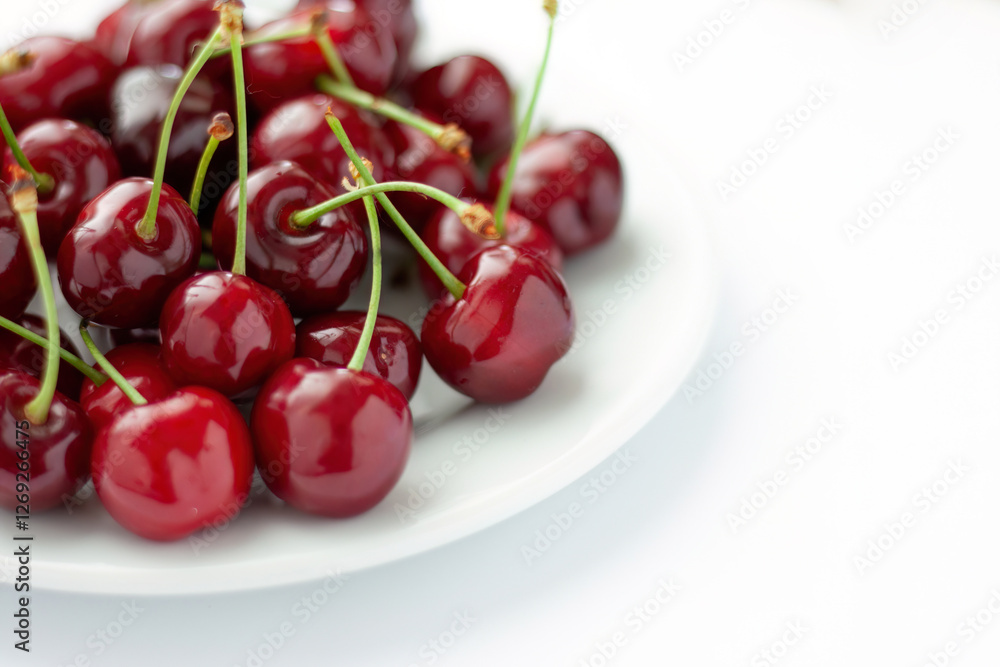 Pile of fresh cherries on a white plate
Pile of fresh cherries on a white plate