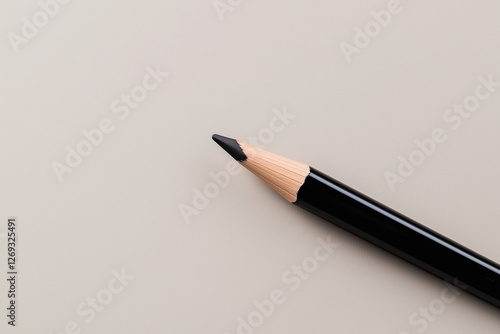 Minimalist black eyeliner pencil mockup with metallic tip on slate gradient surface