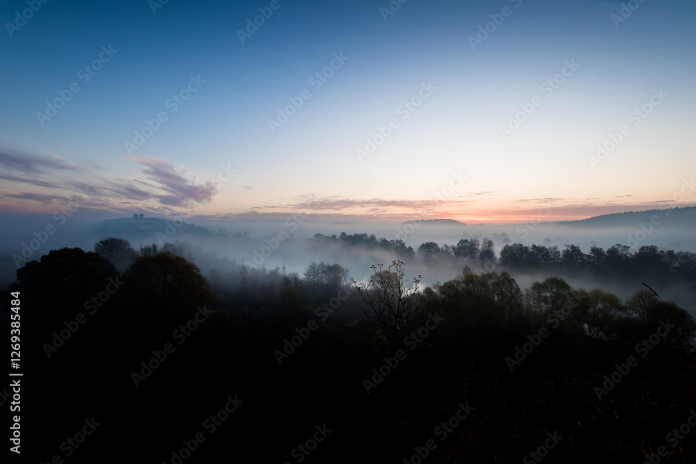 Fototapeta premium Benedictine abbey in Tyniec, foggy autumn sunrise. A monastery is located close to Kraków, Poland.