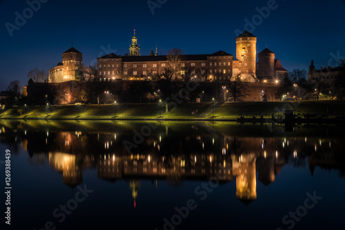 Poland, Krakow: Royal Castle of Wawel by night with reflection in Vistula River