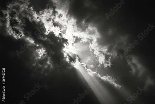 Bright rays pierce through dark clouds creating dramatic sky conditions