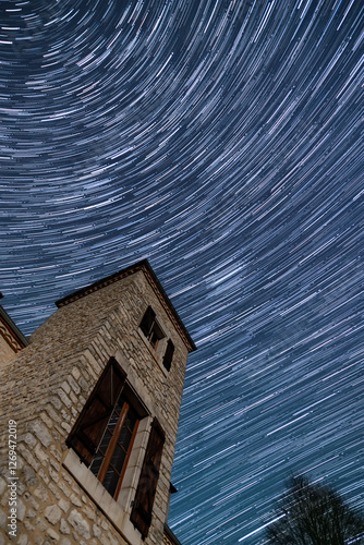 Wallpaper Mural Star trails in the night sky circling above a traditional pigeonnier tower in the Dordogne region of France Torontodigital.ca