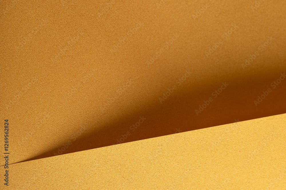 Golden yellow paper background with deep ochre and saffron tones. Layered, folded textures and subtle geometric lines create a soft, elegant, and harmonious abstract design. Golden yellow paper background with deep ochre and saffron tones. Layered, folded textures and subtle geometric lines create a soft, elegant, and harmonious abstract design.