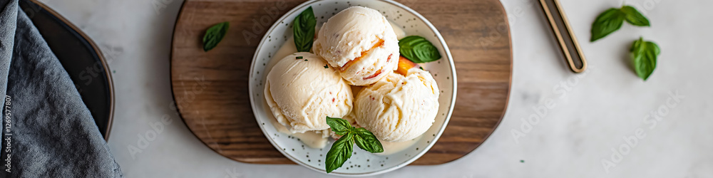 Peach ice cream scoops topped with crumbled biscuits and basil leaves, served in a bowl Peach ice cream scoops topped with crumbled biscuits and basil leaves, served in a bowl