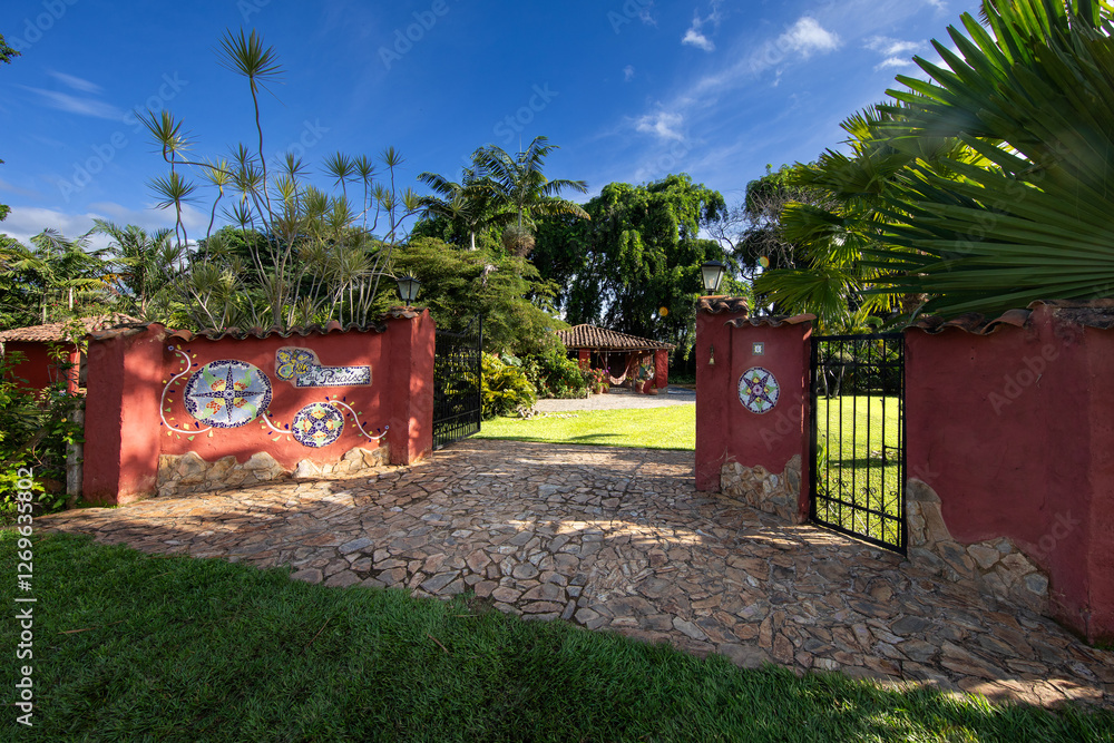 Naklejka premium tropical country home entrance with palm trees