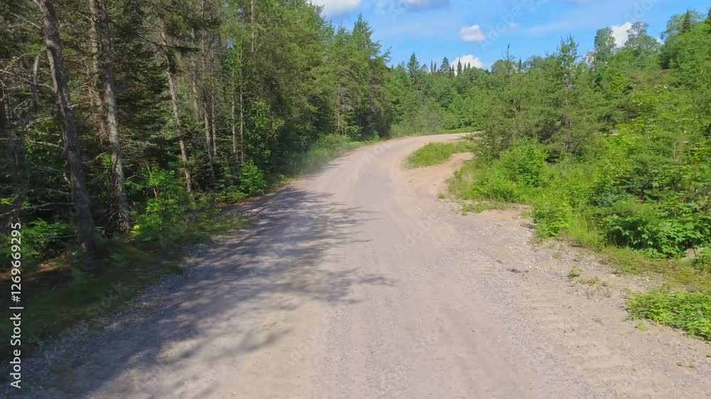 Back plate POV showcasing natural beauty and adventure. Passenger view along gravel road and wilderness pass near crown land of Ontario Canada. Journey on mountains road. Dirt road and off road. Back plate POV showcasing natural beauty and adventure. Passenger view along gravel road and wilderness pass near crown land of Ontario Canada. Journey on mountains road. Dirt road and off road.