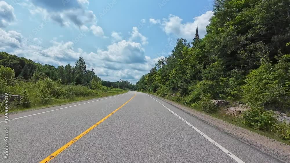 Scenic drive travel by car, front plate, driver person view POV. Asphalt highway in cottage country. Family vacation travel in RV, holiday and adventure trip in Motorized motorhome, Canada. Scenic drive travel by car, front plate, driver person view POV. Asphalt highway in cottage country. Family vacation travel in RV, holiday and adventure trip in Motorized motorhome, Canada.