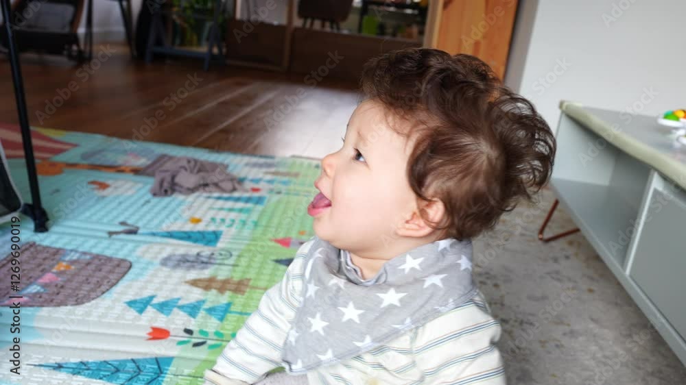 Cute baby sitting, laughing and looking around in slow motion Cute baby sitting, laughing and looking around in slow motion