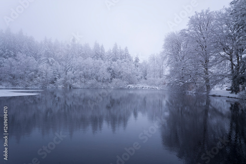 The Haut Folin lake under the snow in Europe, France, Burgundy Franche Comte, Saone et Loire, Saint Prix, in summer, on a sunny day.