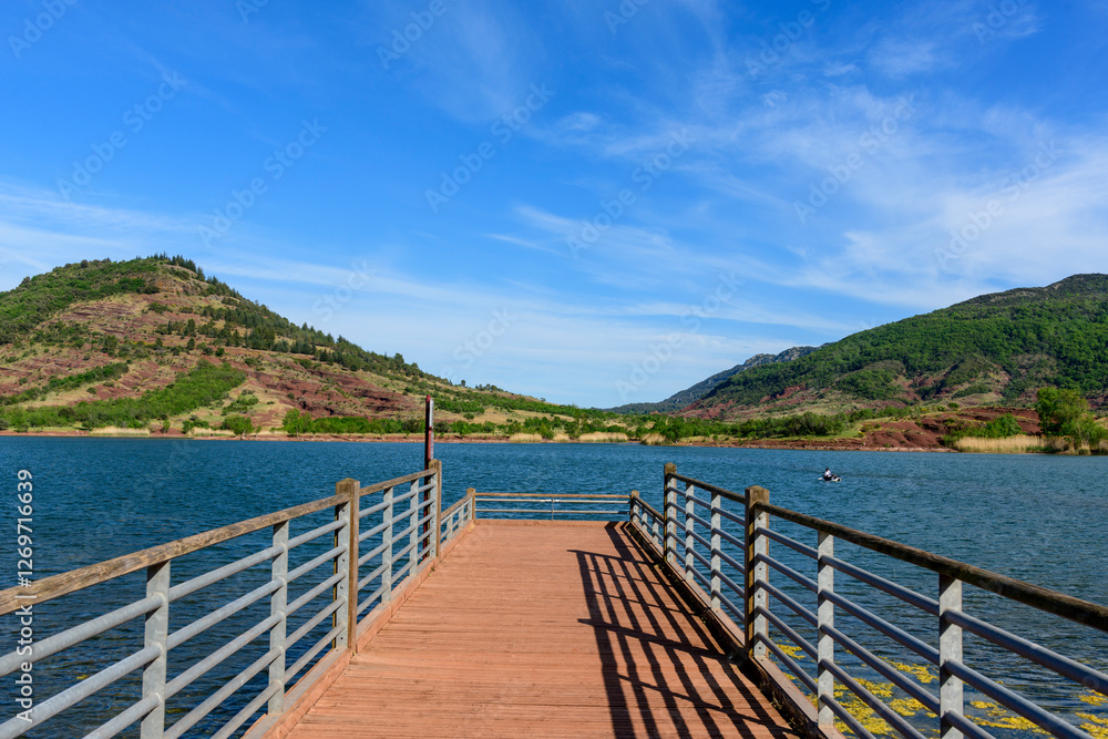 The pontoon of Lake Salagou in Europe, France, Occitanie, Herault, Clermont l Herault, in summer, on a sunny day. The pontoon of Lake Salagou in Europe, France, Occitanie, Herault, Clermont l Herault, in summer, on a sunny day.