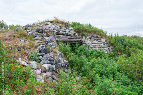 Remains of an old abandoned stone pillbox from the second world war. Sredniy Peninsula, Murmansk region, Northern Russia photo