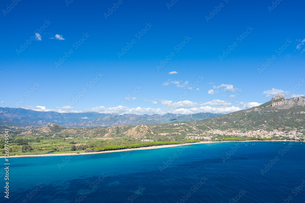 Fototapeta premium The coast seen from the sea in Lotzorai in Europe, Italy, Sardinia, Lotzorai, in summer, on a sunny day.