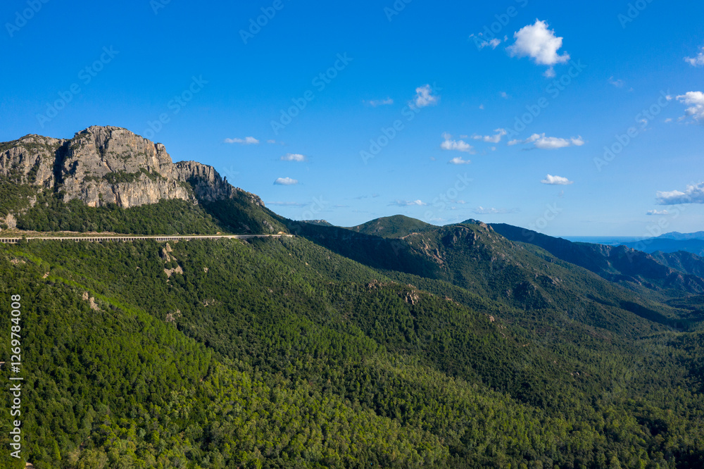 The road in the Sardinian countryside between Baunei and Dorgali in Europe, Italy, Sardinia, Baunei, in summer, on a sunny day.