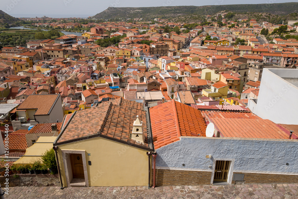 Fototapeta premium The view of the city rooftops in Bosa in Europe, Italy, Sardinia, Bosa, in summer, on a sunny day.