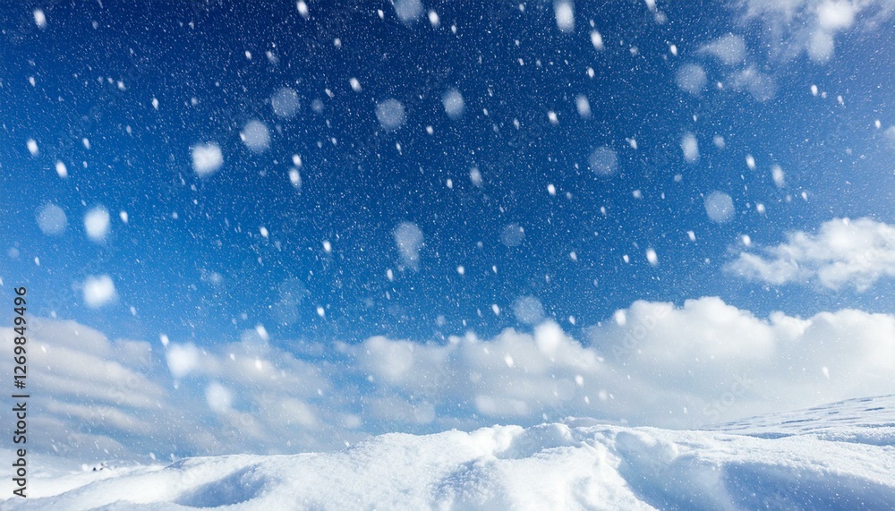 Fototapeta premium snowy wintry sky blurred background of snow falling against cool blue cloudy sky during a winter storm