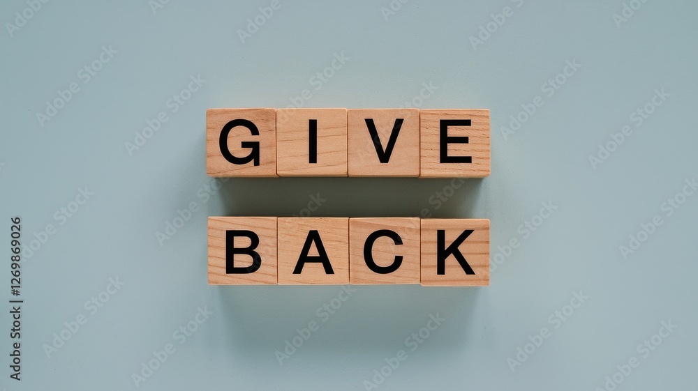 Wooden blocks spell give back on light blue background Wooden blocks spell give back on light blue background