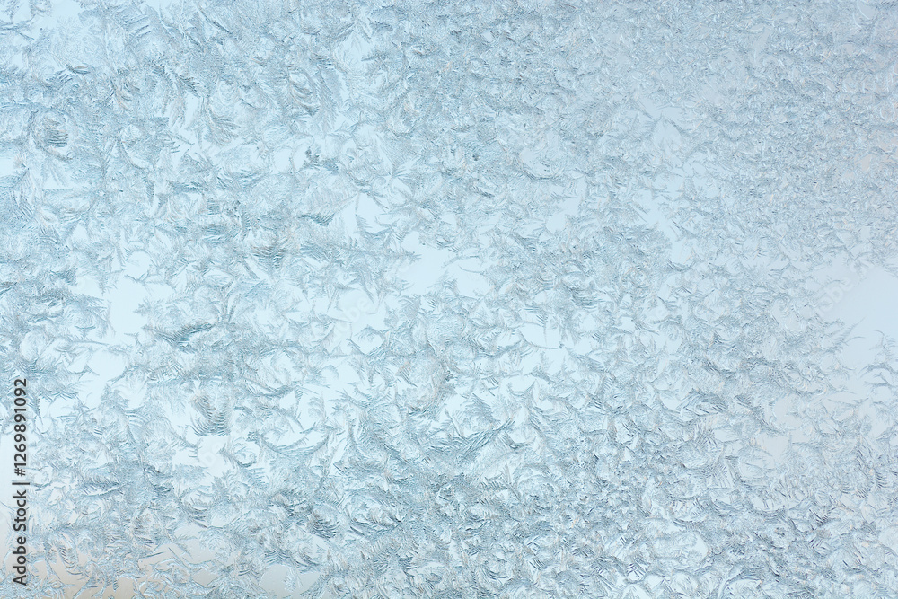 The intricate patterns of frost on a glass surface, creating a delicate, icy texture against a softly blurred background The intricate patterns of frost on a glass surface, creating a delicate, icy texture against a softly blurred background