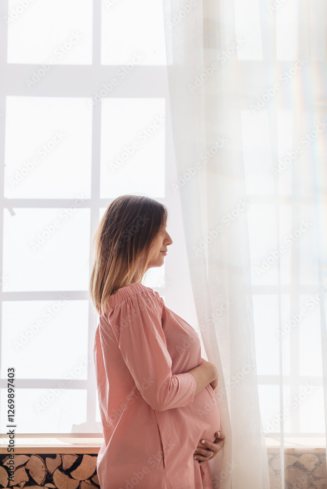 Portrait shot of young beautiful woman on third trimester of pregnancy. Close up of pregnant female with arms on her round belly. Expecting a child concept. Background, copy space. Portrait shot of young beautiful woman on third trimester of pregnancy. Close up of pregnant female with arms on her round belly. Expecting a child concept. Background, copy space.