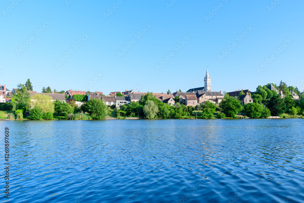 Dampierre-en-Burly view from the pond in Europe, France, Centre Val de Loire, Loiret, Dampierre en Burly, in summer, on a sunny day. Dampierre-en-Burly view from the pond in Europe, France, Centre Val de Loire, Loiret, Dampierre en Burly, in summer, on a sunny day.