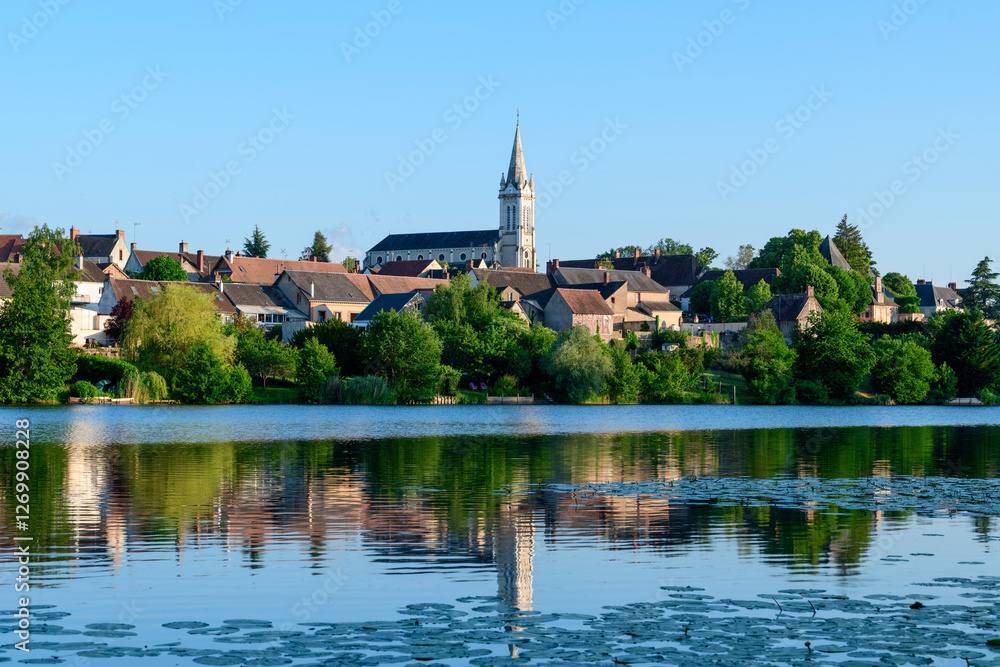 Dampierre-en-Burly view from the pond in Europe, France, Centre Val de Loire, Loiret, Dampierre en Burly, in summer, on a sunny day. Dampierre-en-Burly view from the pond in Europe, France, Centre Val de Loire, Loiret, Dampierre en Burly, in summer, on a sunny day.