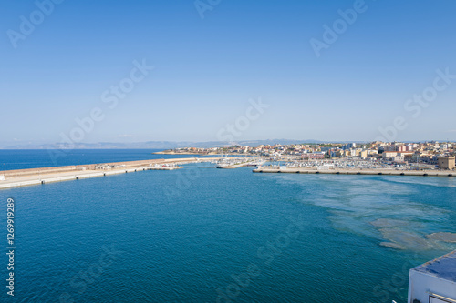 The breakwater at the entrance to the harbor in Porto Torres in Europe, Italy, Sardinia, Porto Torres, in summer, on a sunny day.