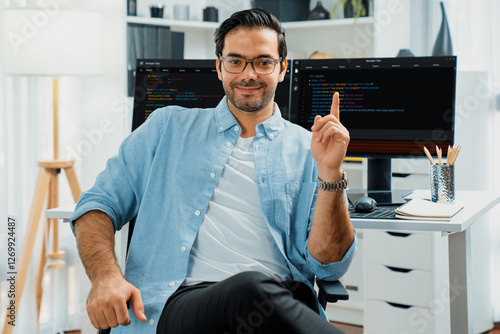 Profile's smart IT developer looking camera to pose wearing glasses against on software development coding on two pc screen, presenting program update online website data at modern office. Surmise. photo