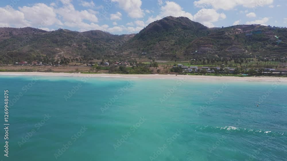 Aerial view of tropical beach with mountains and blue sea in Lombok Aerial view of tropical beach with mountains and blue sea in Lombok
