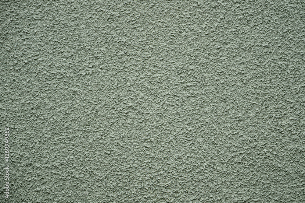 The rough texture of a green wall displays various shades and patterns, capturing light in a way that highlights the surface’s unique characteristics. This setting emphasizes the material's depth The rough texture of a green wall displays various shades and patterns, capturing light in a way that highlights the surface’s unique characteristics. This setting emphasizes the material's depth