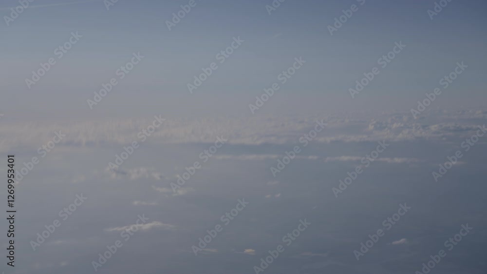 flight over clouds, seen from an airplane window flight over clouds, seen from an airplane window