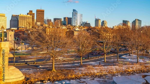 Timelapse view of car traffic and Boston city skyline seen from Longfellow bridge over Charles river during winter sunset photo