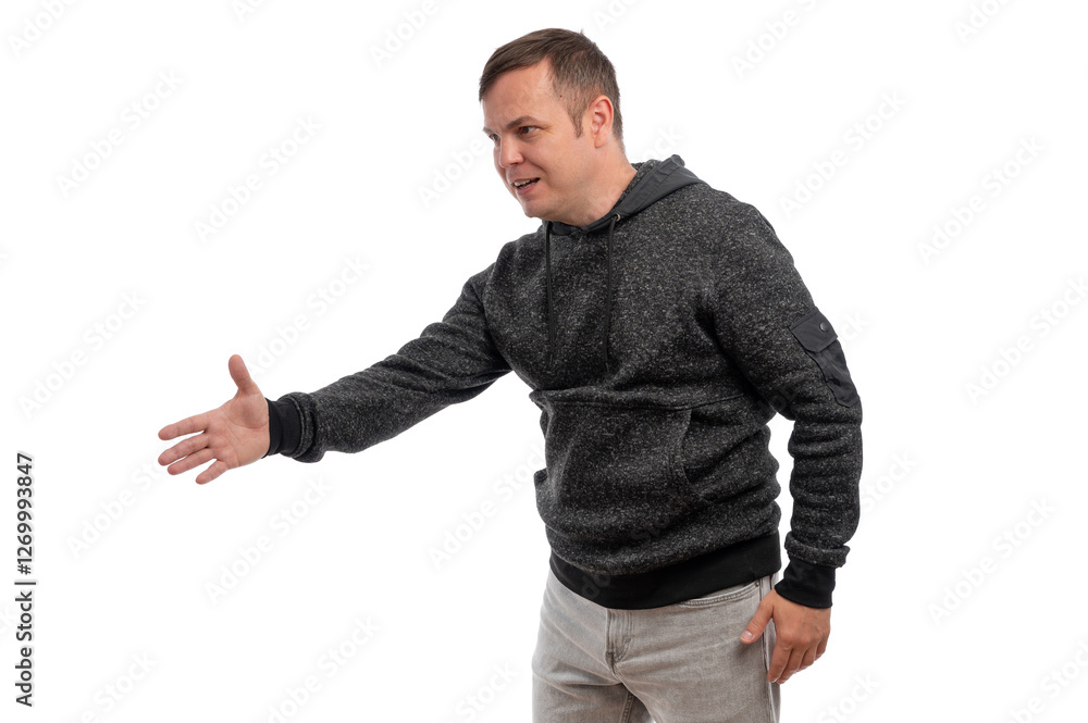 A man in a gray hoodie extending his hand for a handshake against a white background. A man in a gray hoodie extending his hand for a handshake against a white background.