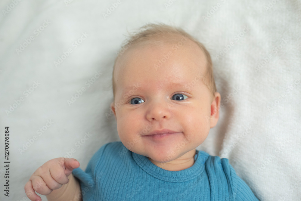 Portrait of baby boy lyingon a white bed. Baby is 2 months old. Happy baby morning. Portrait of baby boy lyingon a white bed. Baby is 2 months old. Happy baby morning.