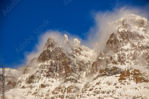 Wind blowing snow away from mountain peak in Andes. Region of El Calafate in Argentina. photo