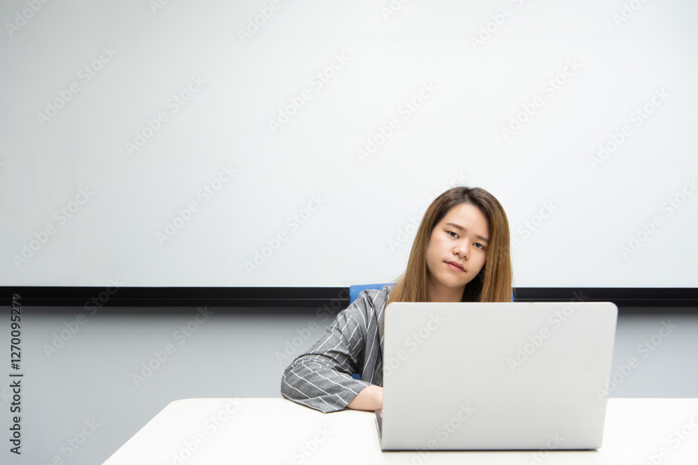 Woman working by laptop in office with happy Woman working by laptop in office with happy