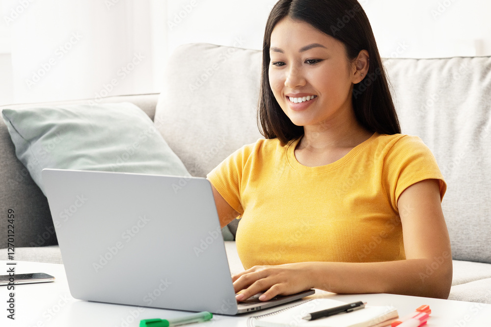 Cheerful young japanese lady surfing on Internet, using laptop at home, cute puppy sitting by. Happy woman spending time with jack russel terrier dog, working online, typing on notebook keyboard Cheerful young japanese lady surfing on Internet, using laptop at home, cute puppy sitting by. Happy woman spending time with jack russel terrier dog, working online, typing on notebook keyboard