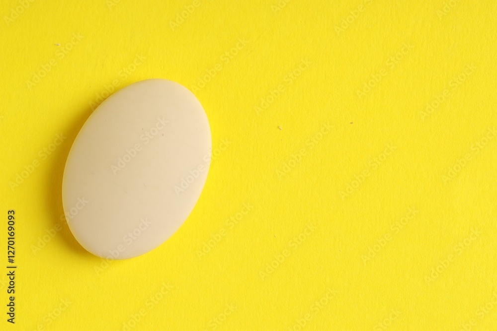 One eraser on yellow background, top view. Space for text One eraser on yellow background, top view. Space for text