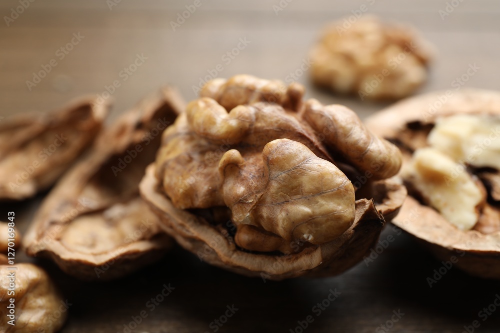 Fresh walnuts with shells on table, closeup Fresh walnuts with shells on table, closeup