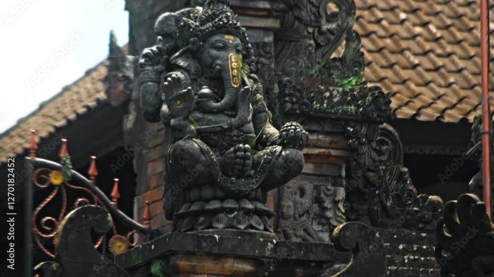 An old stone statue of Ganesha covered with moss. An old stone statue of Ganesha covered with moss.